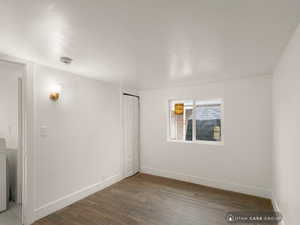 Unfurnished room with hardwood / wood-style flooring