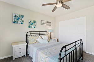 Carpeted bedroom with ceiling fan