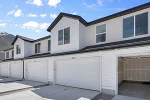 View of front of property with a mountain view and a garage