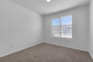 Secondary bedroom with carpet