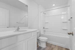 Full bathroom with vanity, LVP floors, bathtub / shower combination and toilet