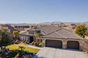 Mediterranean / spanish-style home with a mountain view and a garage