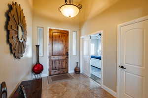 Tiled foyer entrance featuring ceiling fan