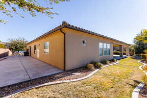 View of side of property with a patio area. New concrete pad.