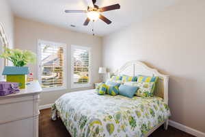 Carpeted bedroom with ceiling fan