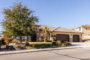 Mediterranean / spanish-style house with a garage