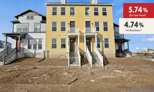 View of front of property featuring a balcony and stucco siding
