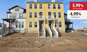 View of front of property with stucco siding and a balcony