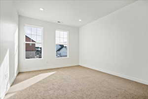 Spare room featuring light carpet