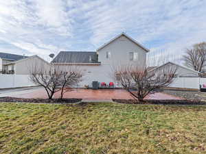 Exterior space featuring a lawn, a patio, and central AC