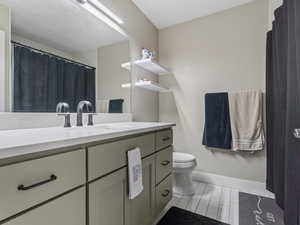 Bathroom featuring vanity and toilet