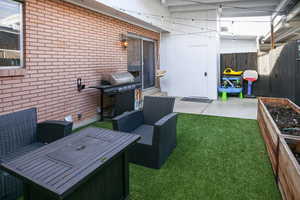 View of patio featuring an outdoor hangout area and grilling area