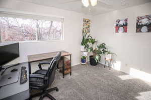 Home office featuring ceiling fan and carpet floors