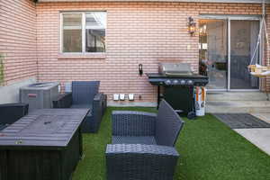 View of patio with central AC unit and a grill