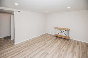 Unfurnished room with light hardwood / wood-style floors