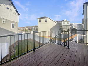 Wooden terrace featuring a yard