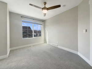 Empty room with carpet flooring and ceiling fan