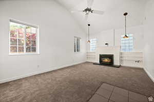 ADU - large living room with carpet, ceiling fan, high vaulted ceiling, and a brick fireplace