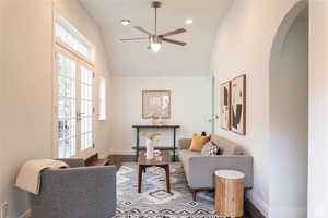 Family room area with french doors, vaulted ceiling, ceiling fan.