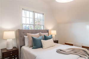 Bedroom with lofted ceiling