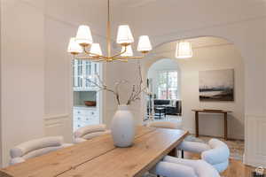 Dining room with hardwood / wood-style flooring and chandelier