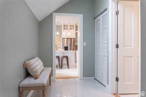 Hallway featuring vaulted ceiling