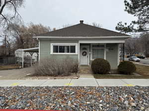 Bungalow featuring a carport