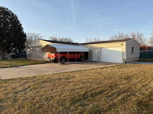 Garage with a yard and a carport