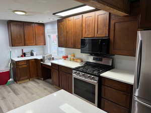 Kitchen featuring light wood-type flooring and stainless steel appliances