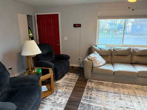 Living room featuring dark hardwood / wood-style floors and a textured ceiling