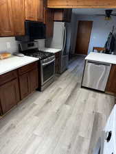 Kitchen featuring appliances with stainless steel finishes, light wood-type flooring, and ceiling fan