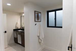 Bathroom with tile patterned flooring and vanity