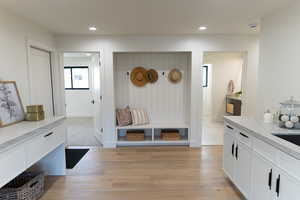 Mudroom with light hardwood / wood-style flooring