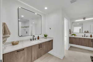 Bathroom featuring a shower and vanity