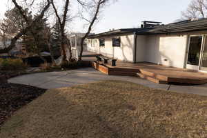 Back of house featuring a wooden deck