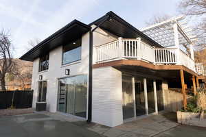 Rear view of property featuring cooling unit, a pergola, and a patio