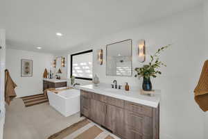 Bathroom featuring tile patterned floors, vanity, and plus walk in shower