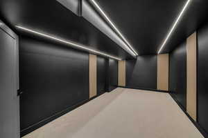 Cinema room with elevator and carpet flooring