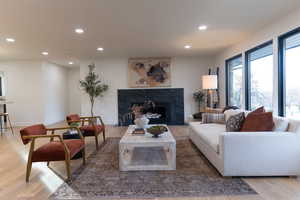 Living room featuring hardwood / wood-style floors and a premium fireplace