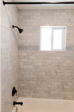 Bathroom featuring tiled shower / bath combo