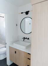 Bathroom with tile patterned flooring, vanity, and toilet