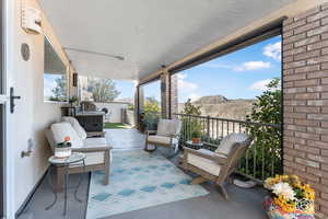 View of patio with a mountain view and a balcony