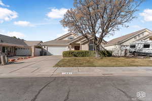 View of front of home featuring a front yard and a garage