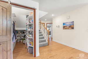 Staircase featuring hardwood / wood-style floors and a barn door