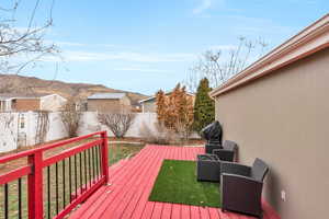 Deck featuring a mountain view and a yard