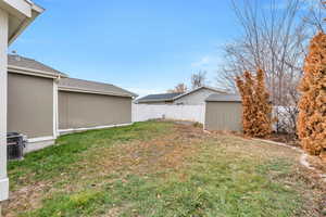 View of yard featuring central AC unit and a storage shed