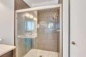 Bathroom with vanity and a shower with shower door