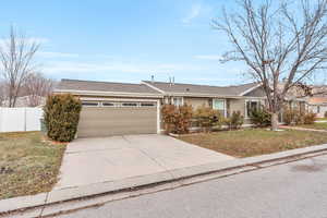 Ranch-style house with a front lawn and a garage