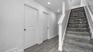 Stairway featuring hardwood / wood-style floors