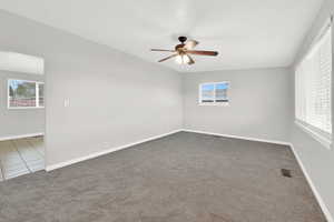 Carpeted living room with ceiling fan